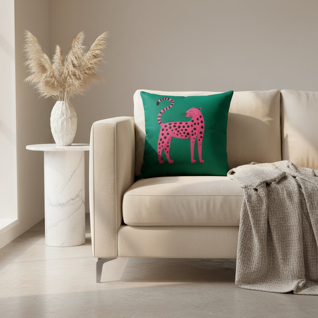Green pillow with a pink and black polka dot leopard design on a white background