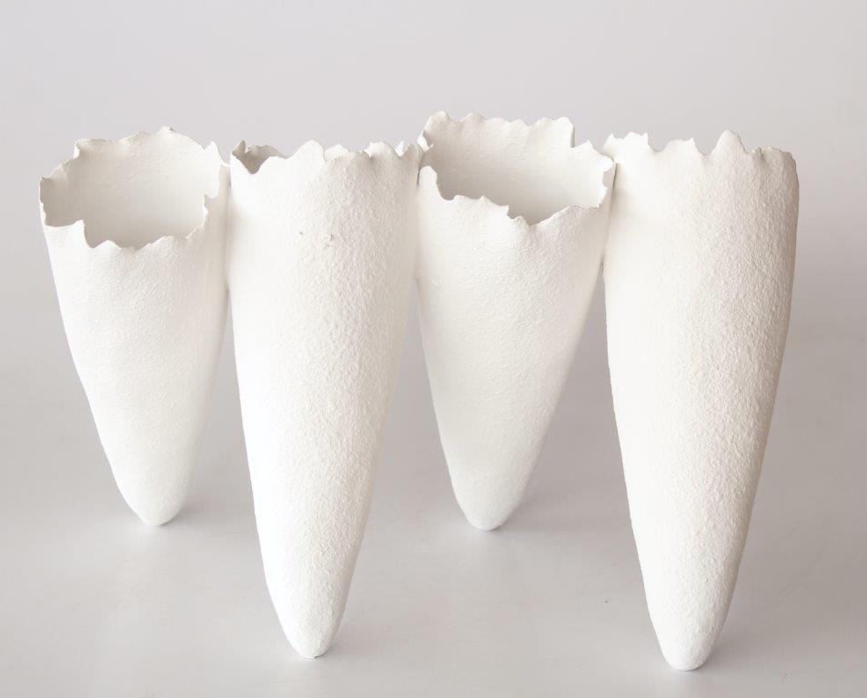 4 White Ceramic Joined Vases at an Angle