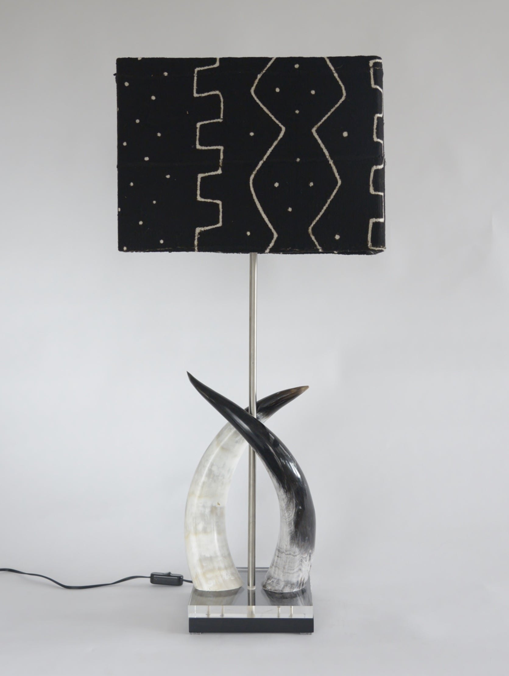 Cow horn duo lamp on perspex base and black mud cloth shade