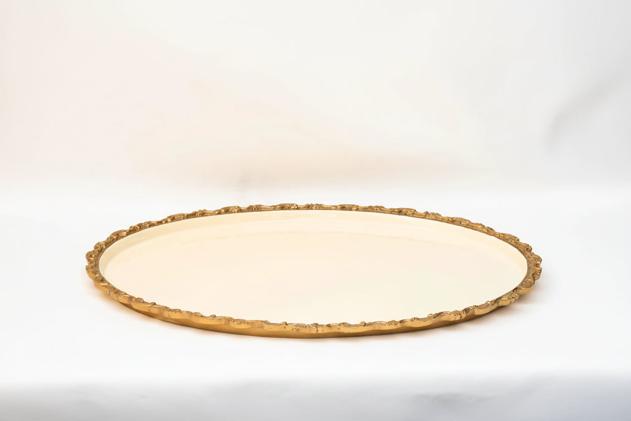 Round ceramic plate with decorative gold rim on a white background