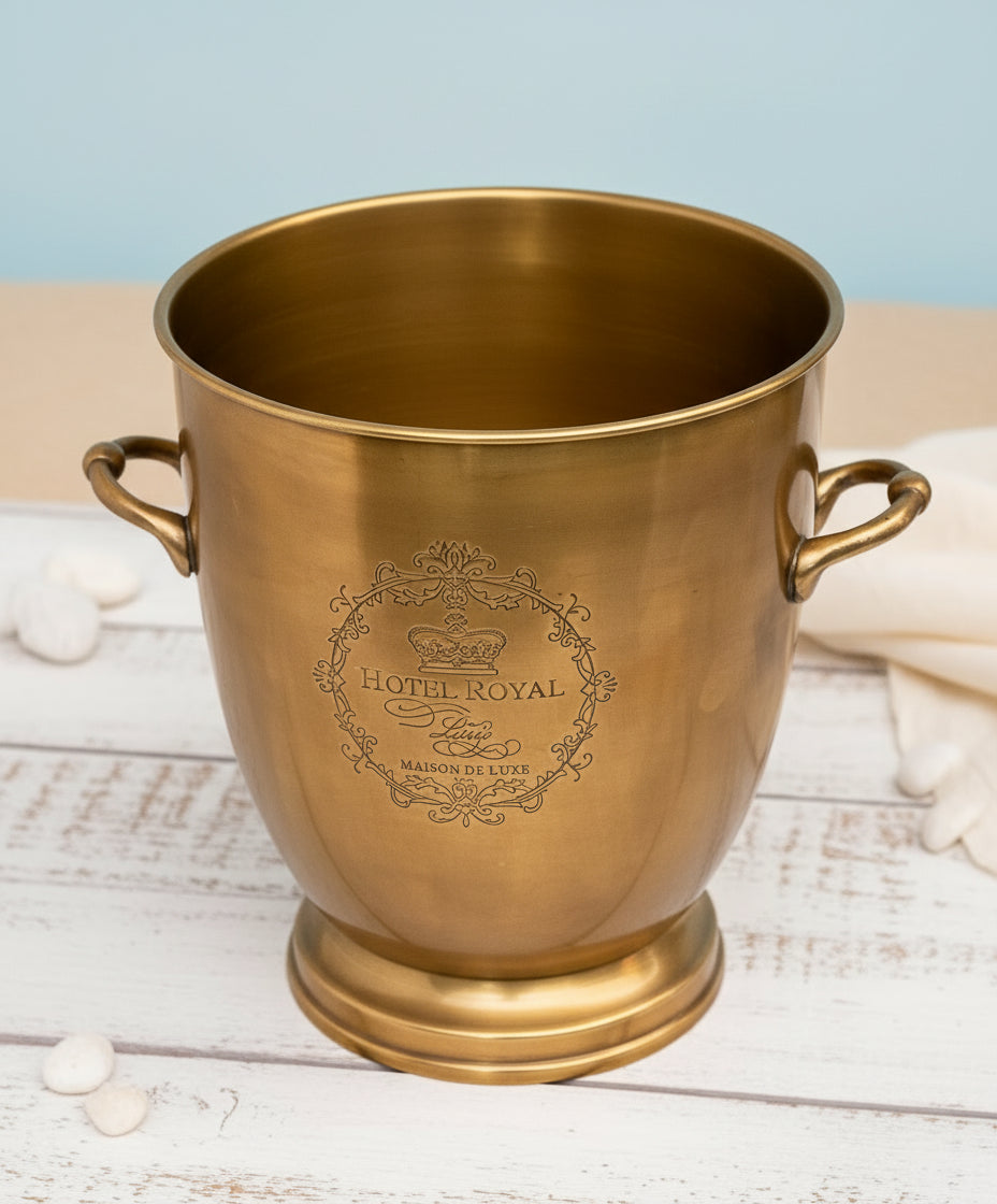 Gold ice bucket with 'Hotel Royal' engraving on a white background
