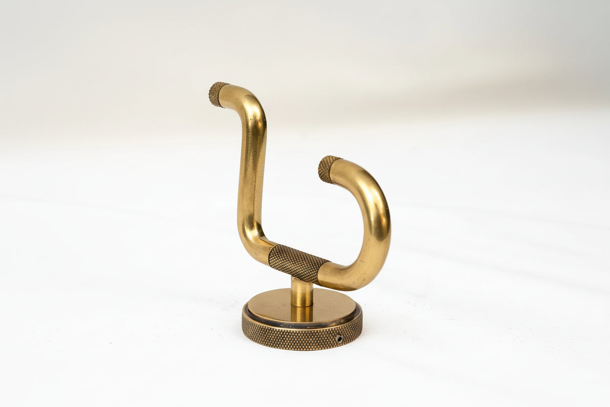 Brass towel hook on a white background