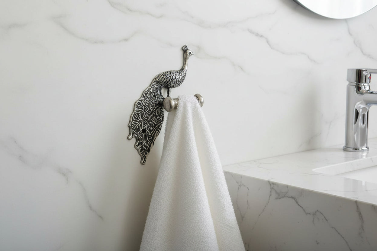 Decorative silver peacock design on a gray background