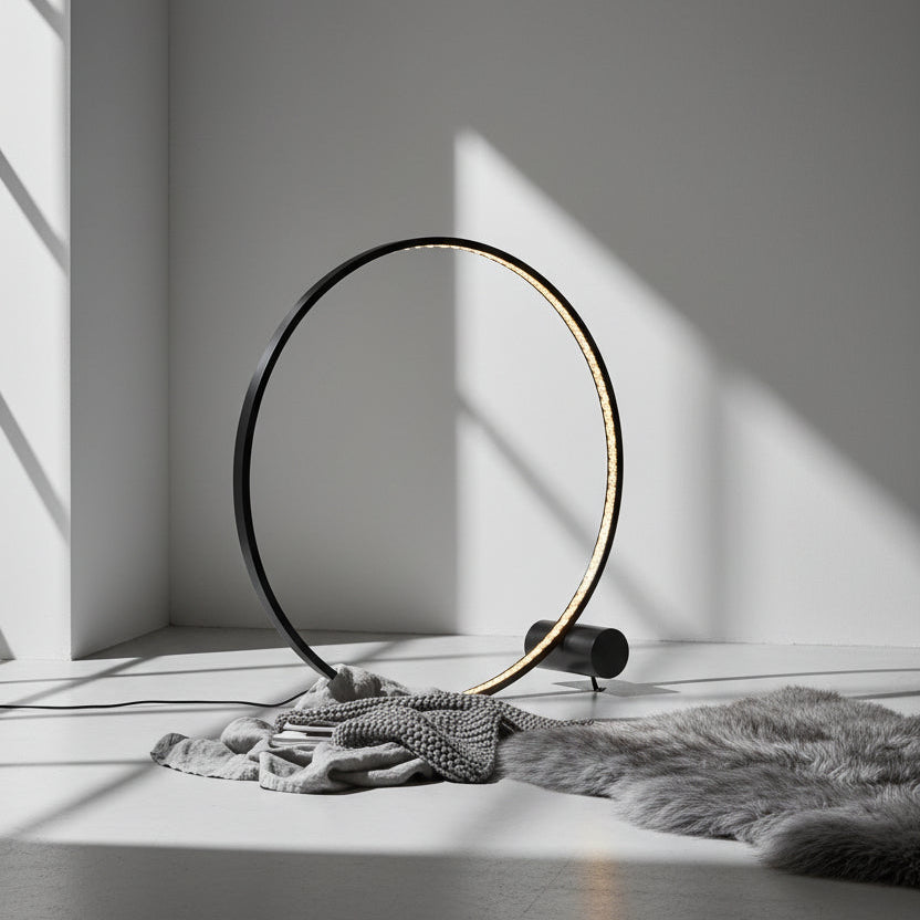 Black circular light fixture on a black background
