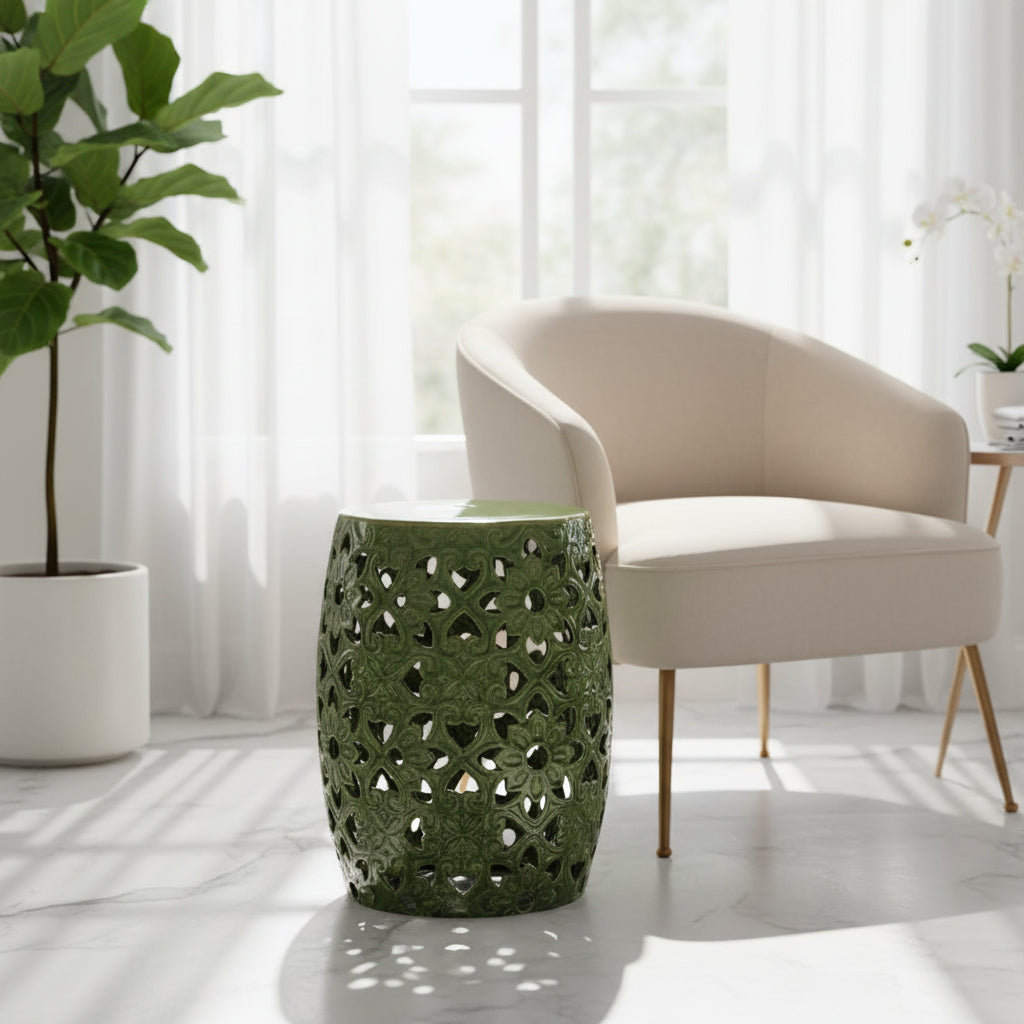Green ceramic garden stool with intricate lace-like pattern on a white background