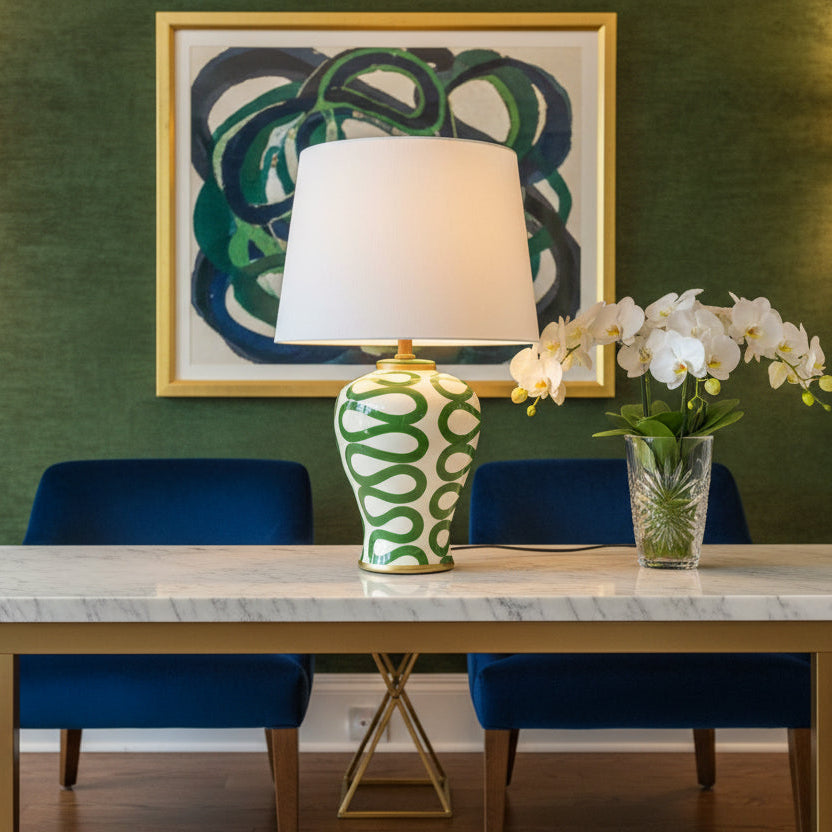 Table lamp with green and white patterned base on a plain background
