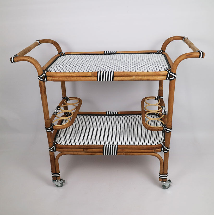 Introducing our luxurious Rattan Thick &amp; Synthetic Drink Trolley in Black &amp; White. Perfect for serving drinks in style, this trolley boasts a sleek rattan design and durable synthetic material. Elevate your entertaining game with this chic and sophisticated addition to your home.