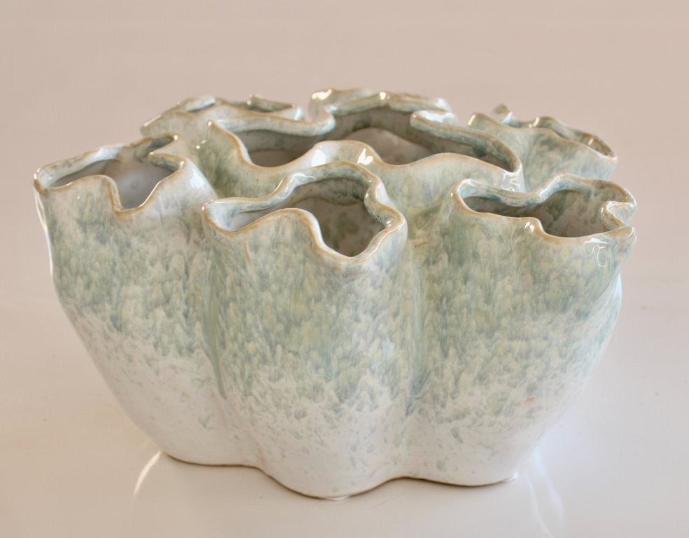 Ceramic vase with textured surface on a beige background