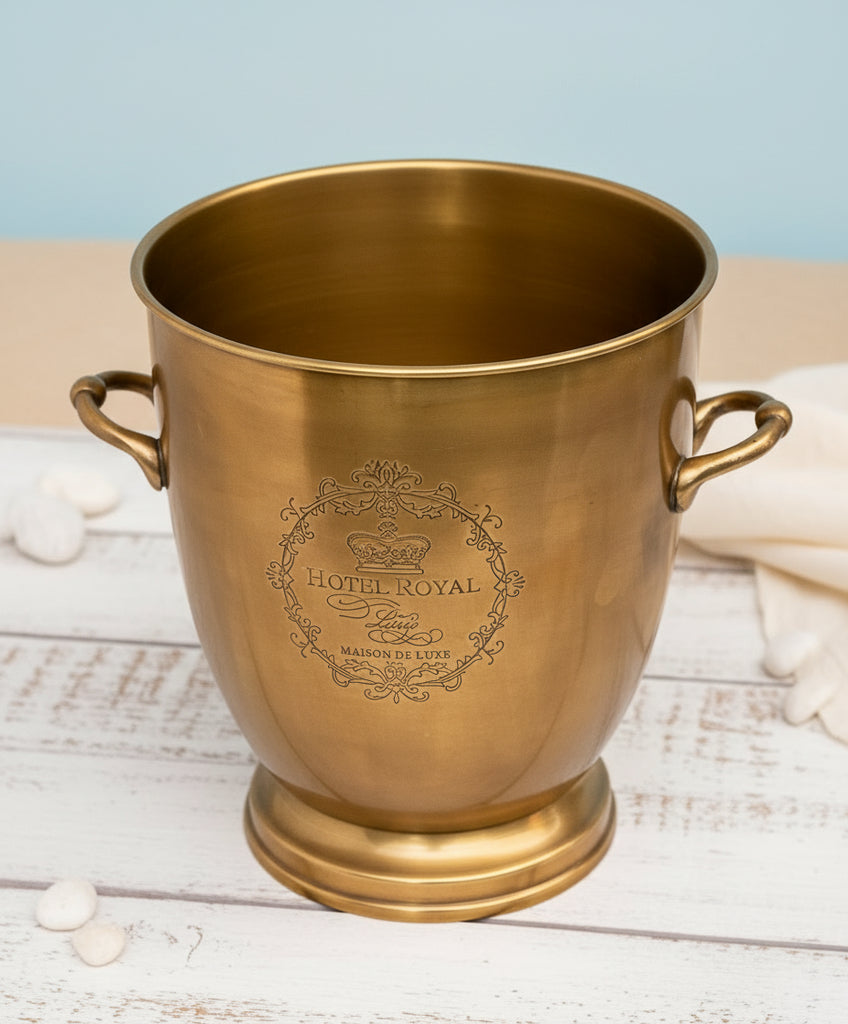 Gold ice bucket with 'Hotel Royal' engraving on a white background