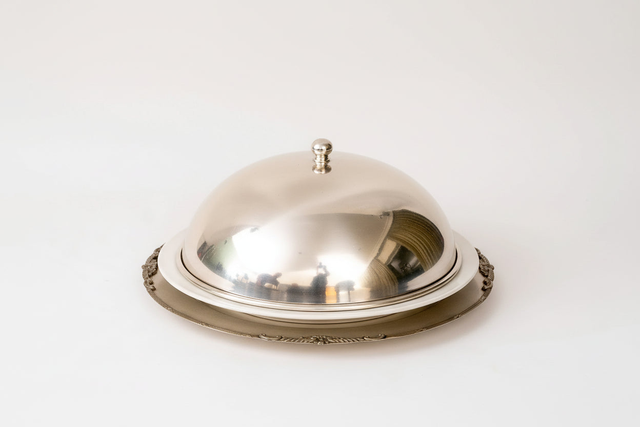 Round metallic object with reflective surface on a white background