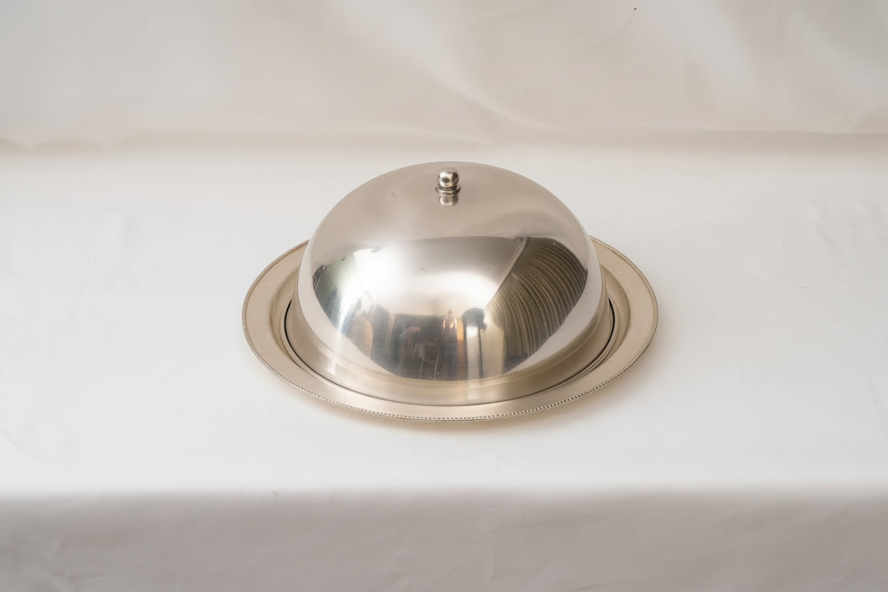 Metallic dome light fixture on a white background