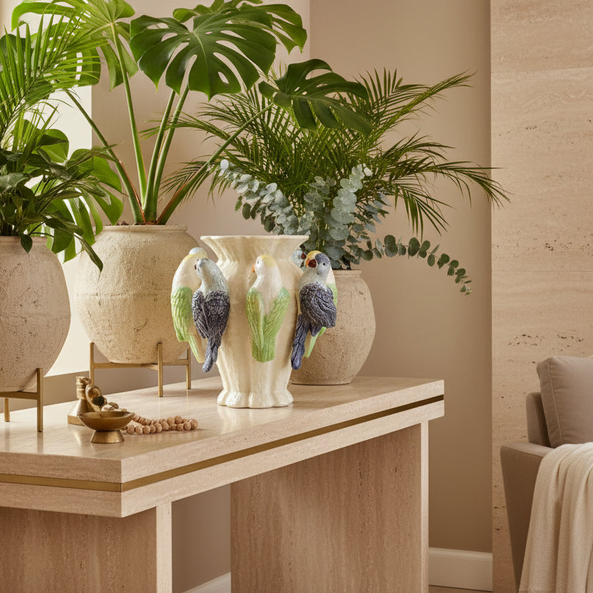Decorative vase with ceramic parrot figures on a beige background
