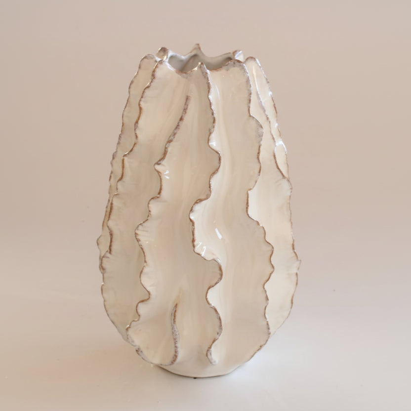 Decorative vase with wavy design on a beige background