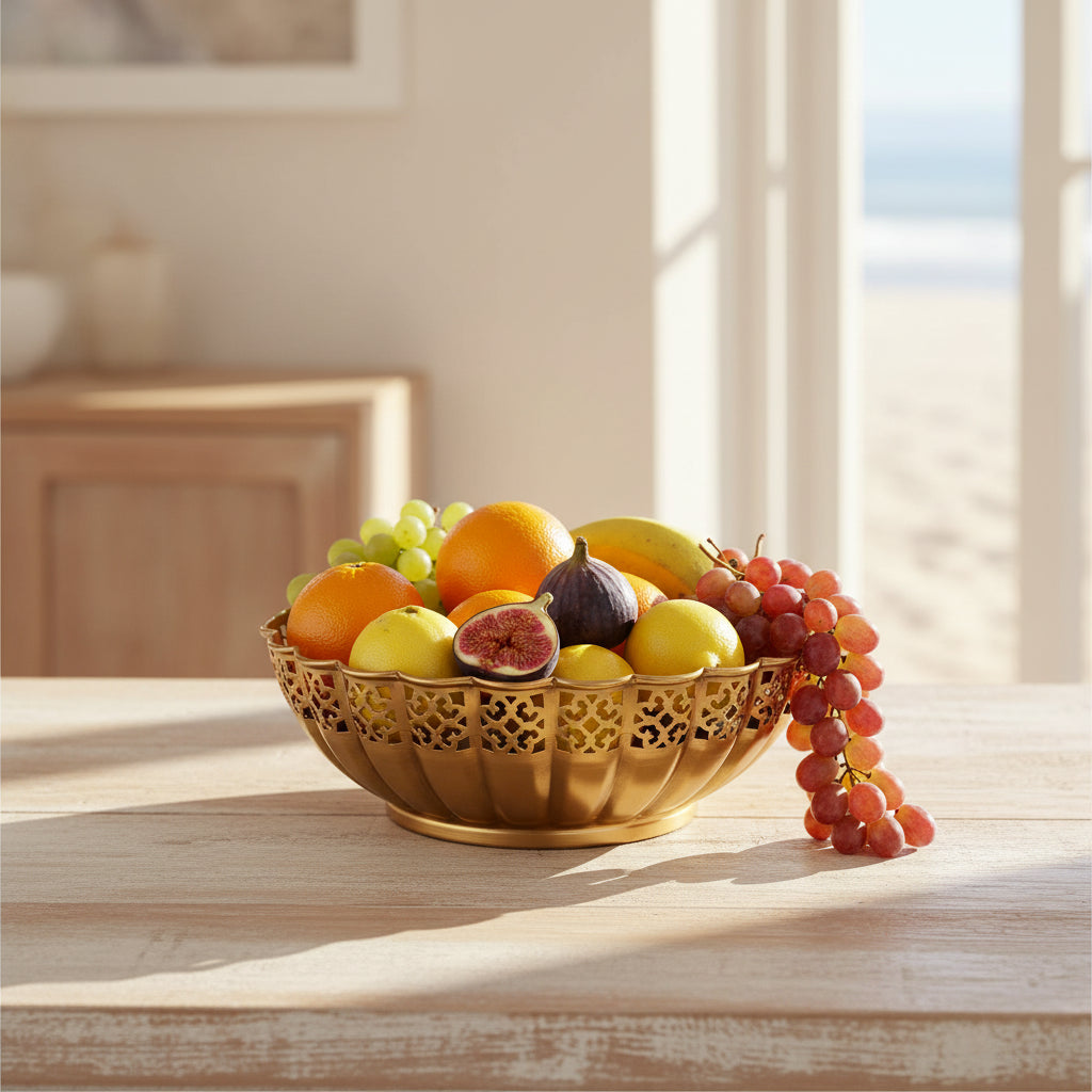 A gold-colored metal bowl with a decorative perforated cutout pattern and a fluted rim, shown on a plain white background.