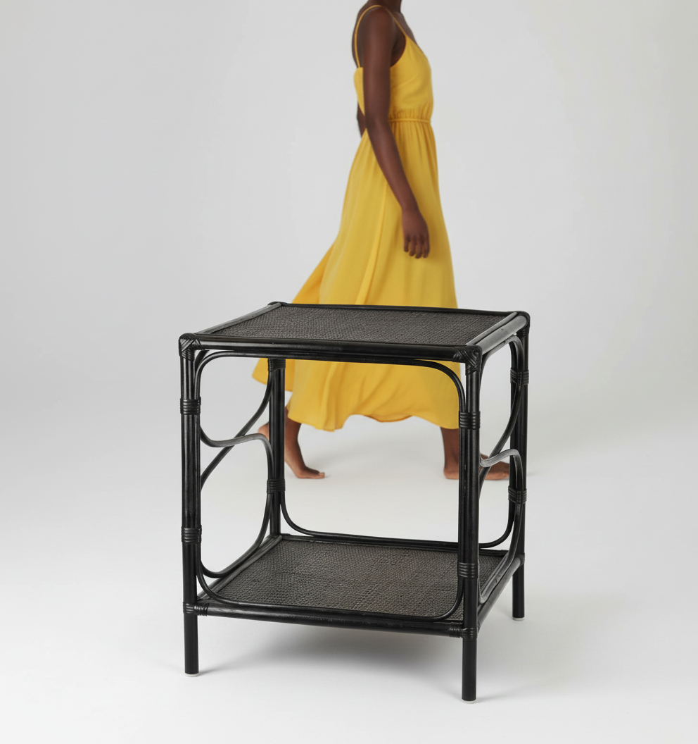 Black rattan side table on a white background