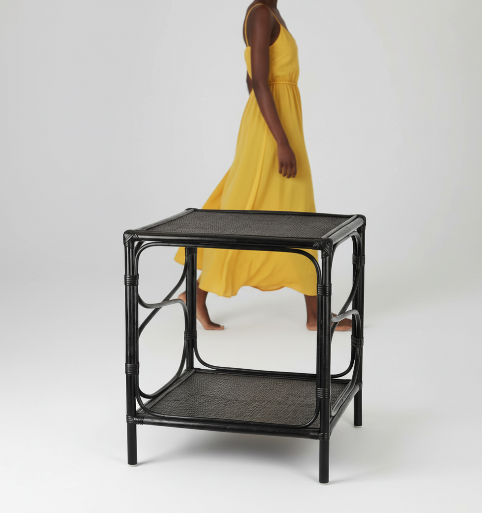 Black rattan side table on a white background