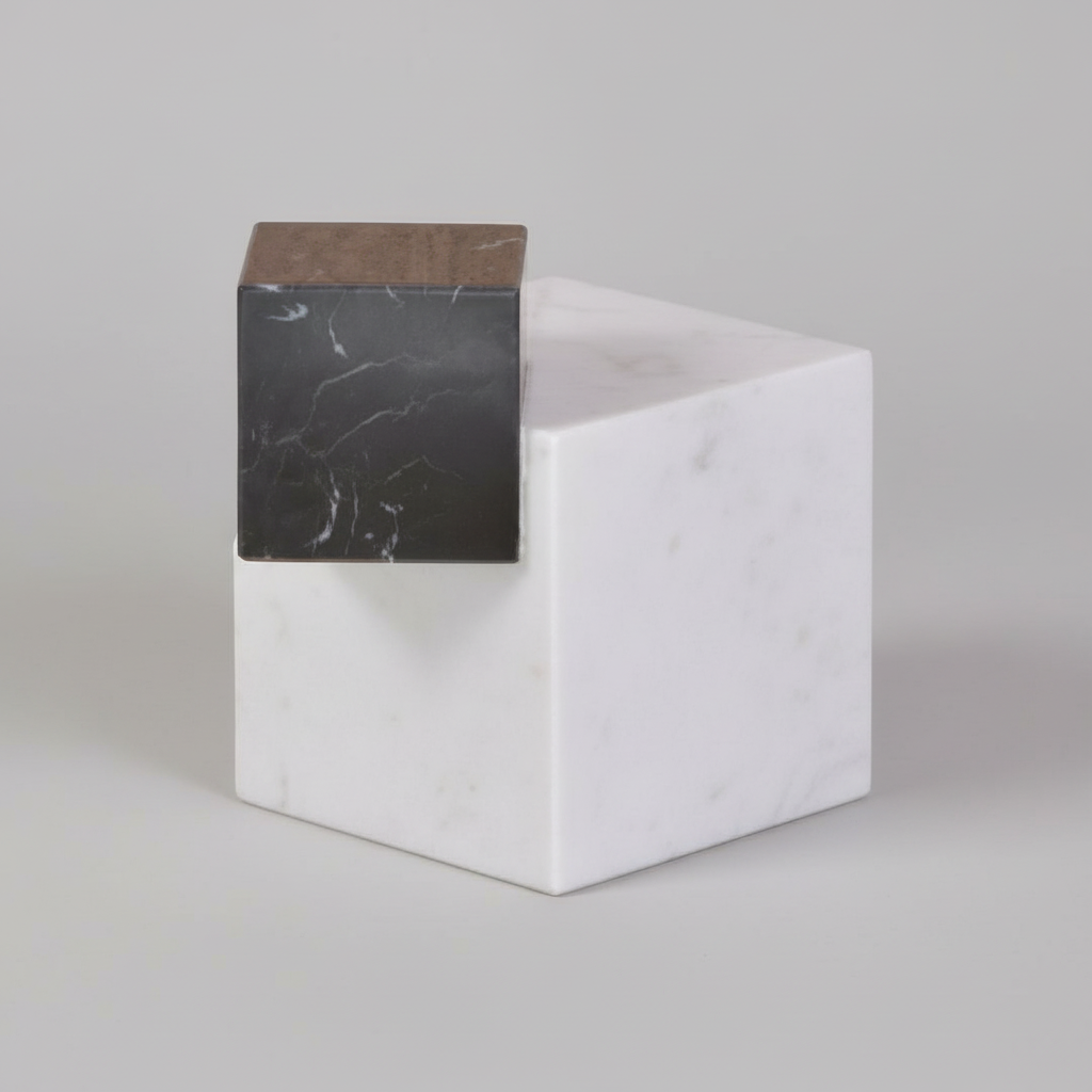 White cube with a black marble-textured side on a white background