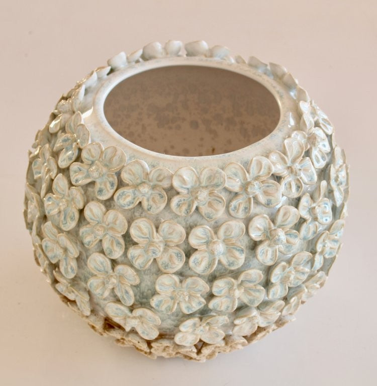 Decorative ceramic vase with floral patterns on a beige background