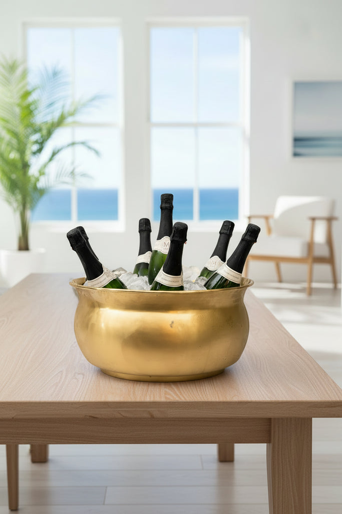 Gold ice bucket with champagne bottles on a white background
