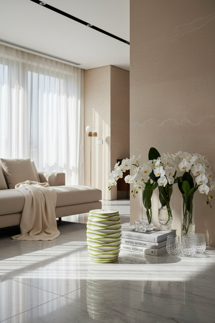 Decorative garden stool with green and white spiral pattern on a light gray background